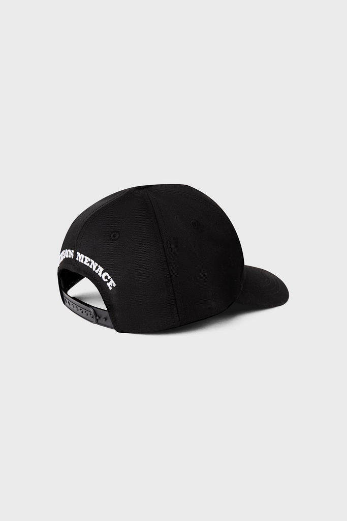 The Maison Menace Signature Hat in Black by MAISON MENACE features MISSION MENACE embroidered in white on the back, is made from durable polyester canvas with a snapback closure, and is displayed showing the back and part of the side against a plain gray background.