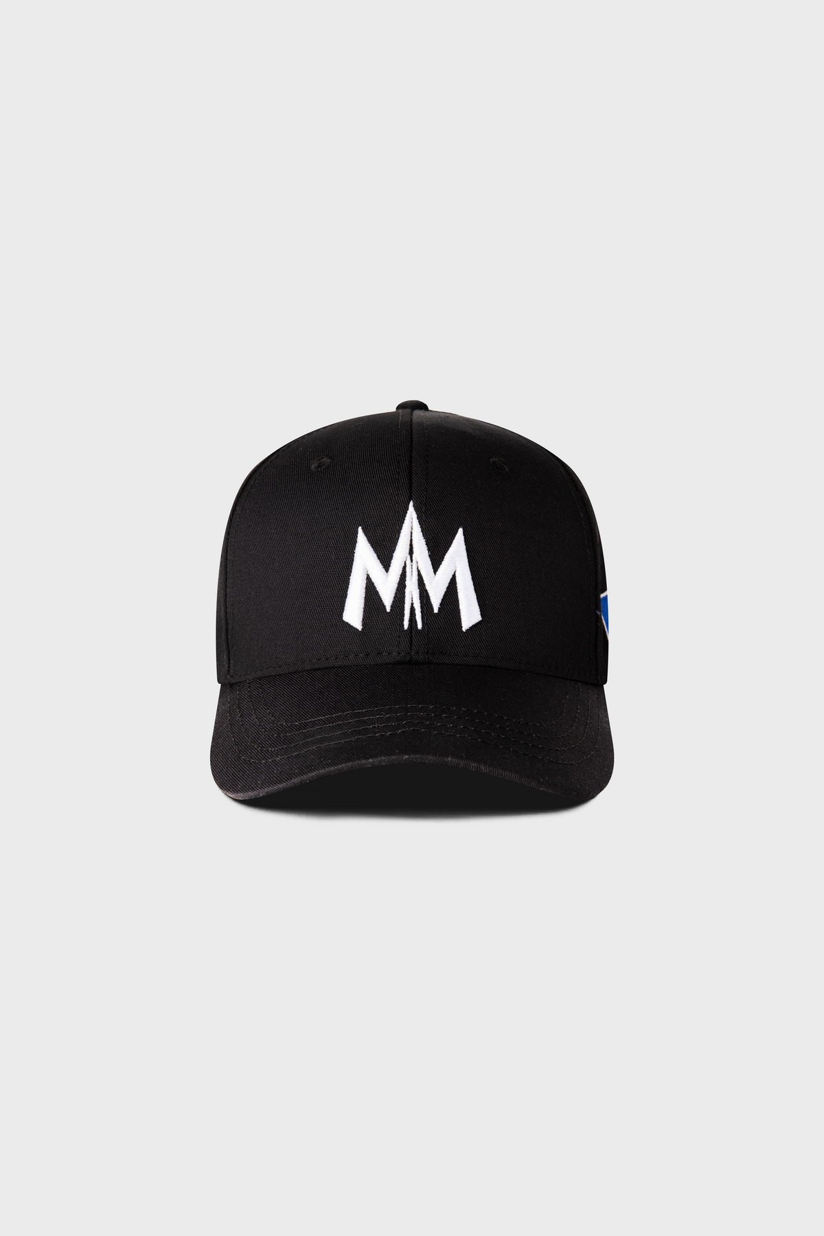 The Maison Menace Signature Hat in Black by MAISON MENACE is a cotton twill cap featuring an embroidered white MM logo on the front.