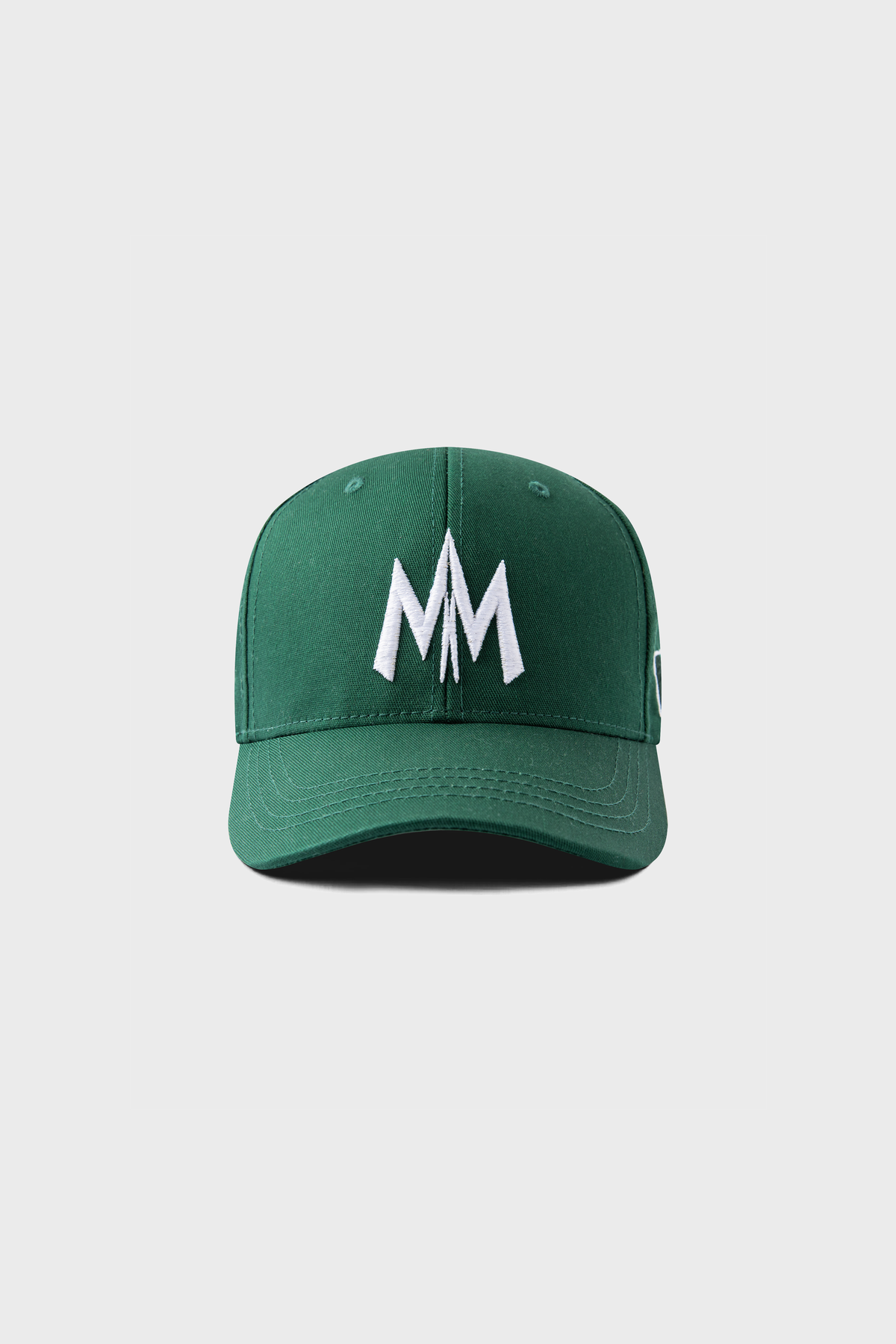 From MAISON MENACE, the Maison Menace Signature Hat in Cactus showcases white MM embroidery on a plain green background.