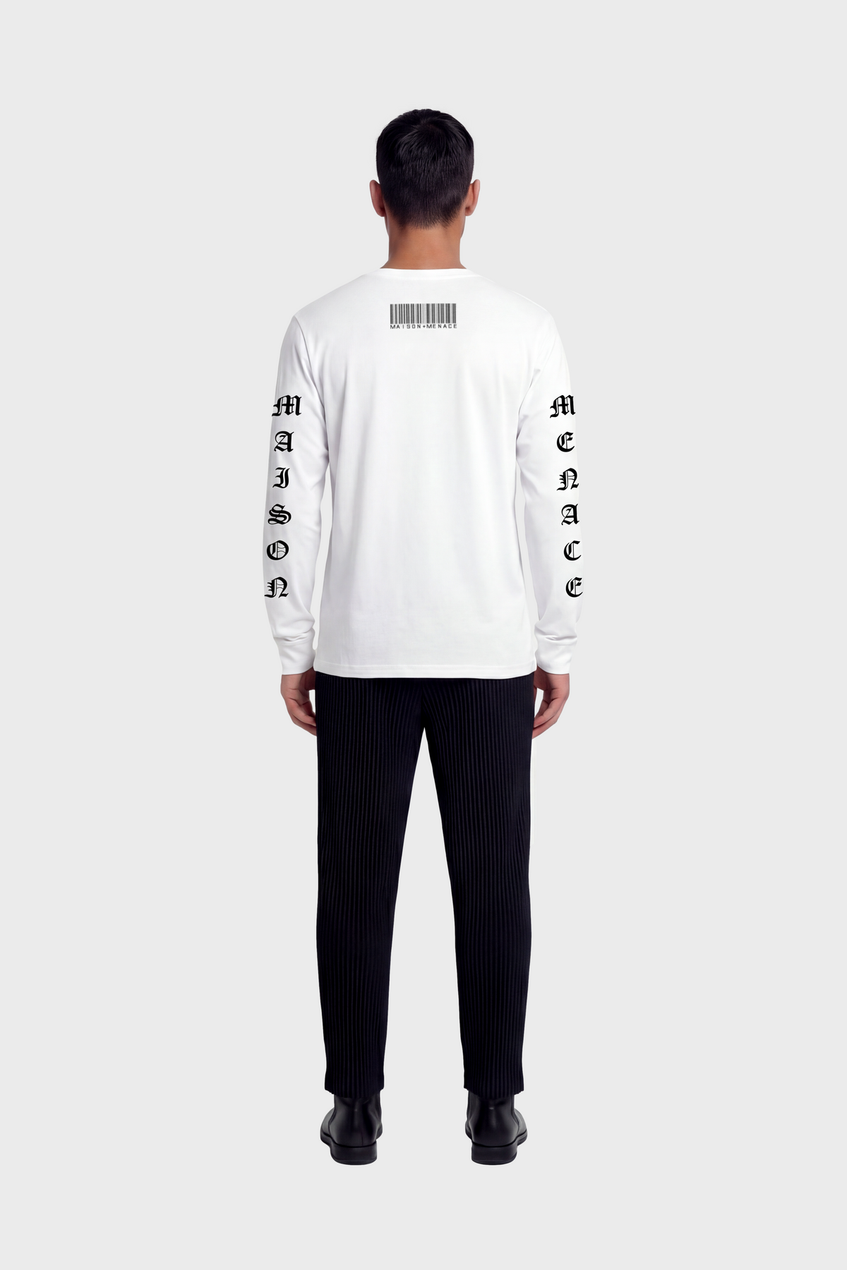 Man wearing a white long-sleeve t-shirt with black text and graphics on back and sleeves against white background