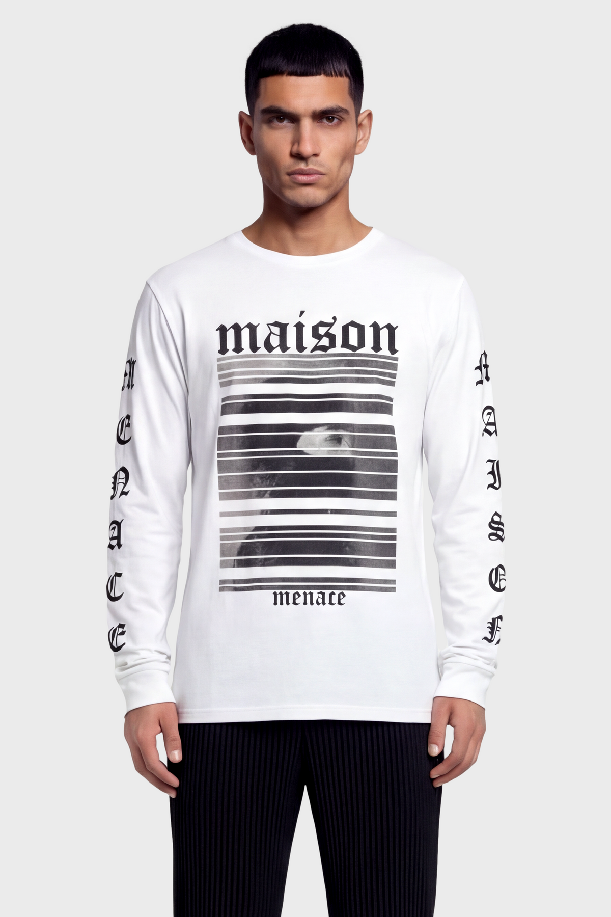 Man wearing a white long-sleeve t-shirt with black text and graphics on front and sleeves against white background