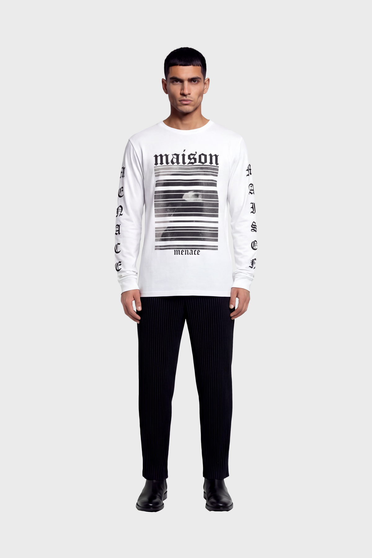 Man wearing a white long-sleeve t-shirt with black text and graphics on front and sleeves against white background