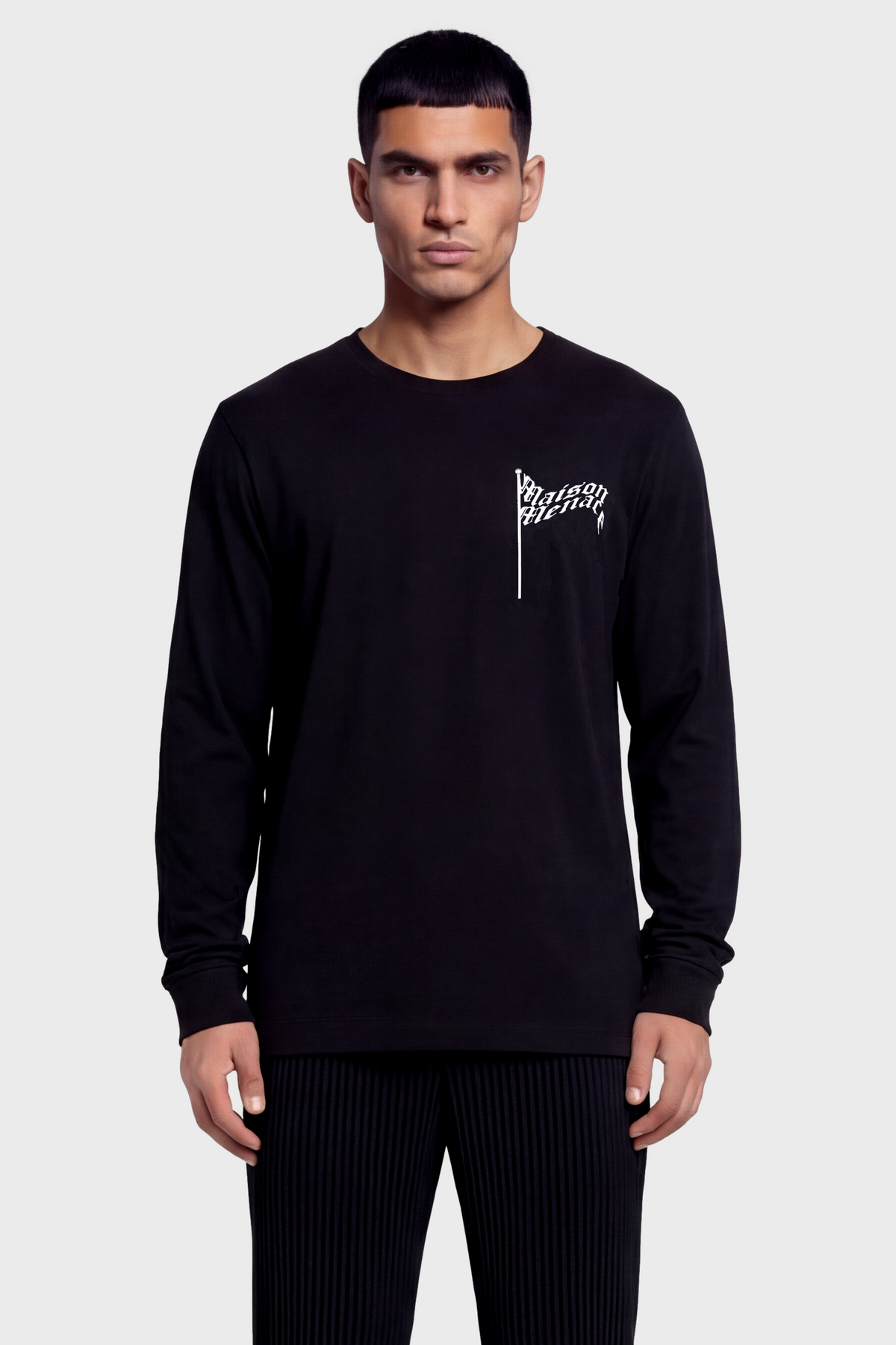 Man wearing a black long-sleeve t-shirt with a flag logo on a white background