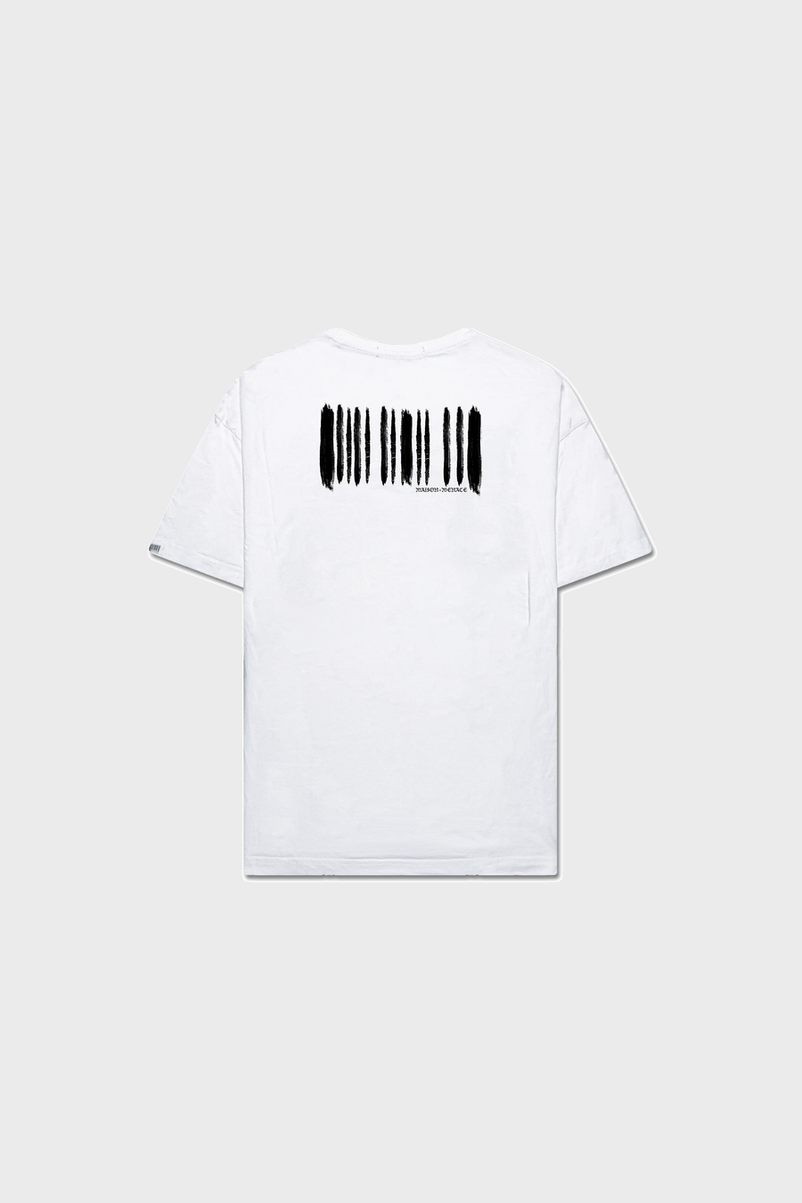 The BARCODE PAINT T-SHIRT by MAISON MENACE features black brushstroke-like patterns vertically on the back, crafted from organic American-grown SUPIMA® cotton. The white T-shirt is displayed flat against a plain neutral background.