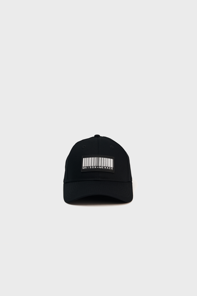A black cotton canvas Maison Menace Classic Hat featuring a barcode design and the text MAYBE ITS MY NAME sits against a light gray backdrop. Its centered in the image with an adjustable Velcro closure, adding a hint of mystery to its style from MAISON MENACE.