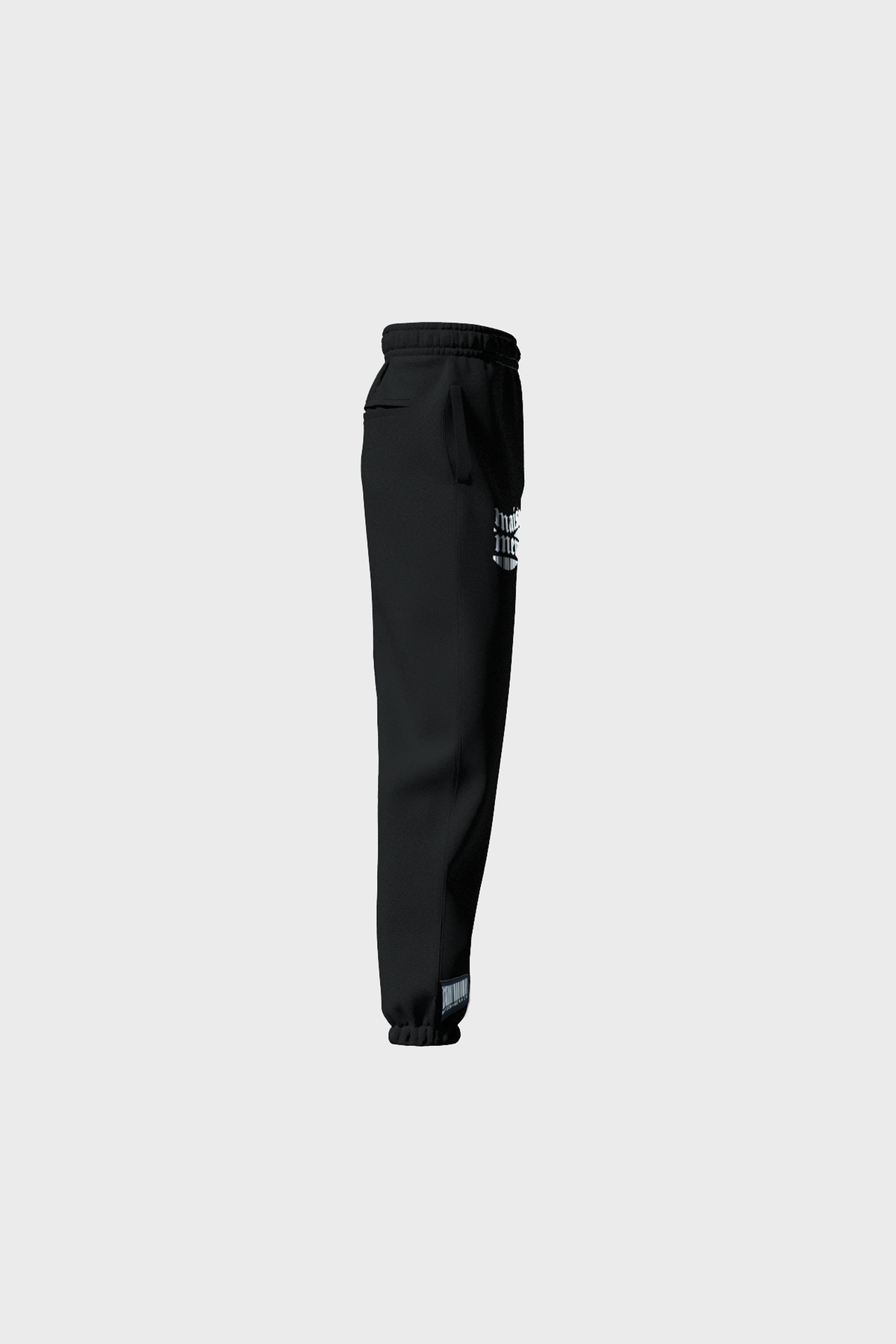 Side view of MAISON MENACEs Gothique Sweatpants in jet black cotton with a white logo on the upper side, featuring an elastic waistband and cuffs. Expertly crafted in Portugal, these sweatpants are showcased on a light gray background.