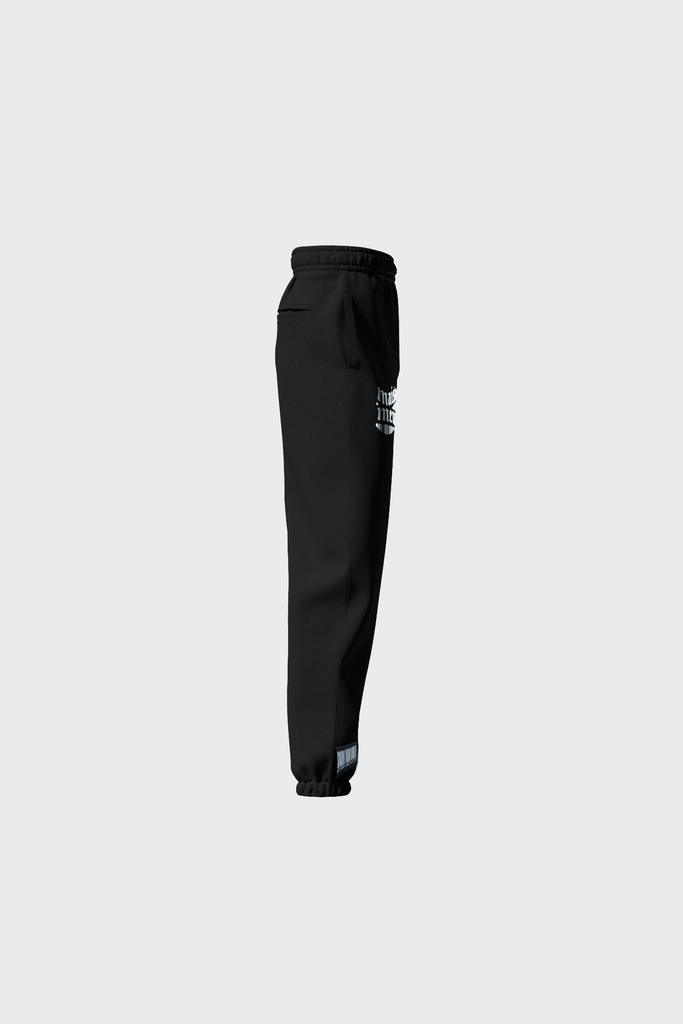 Side view of MAISON MENACEs Gothique Sweatpants in jet black cotton with a white logo on the upper side, featuring an elastic waistband and cuffs. Expertly crafted in Portugal, these sweatpants are showcased on a light gray background.