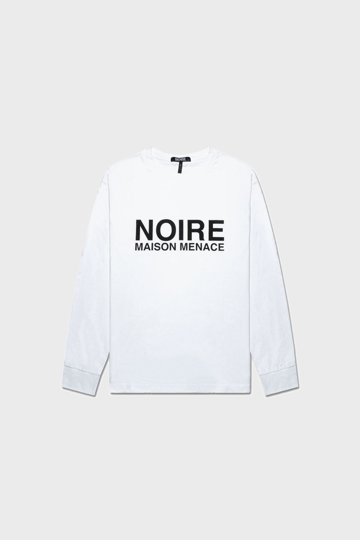 The Noire Classic Long Sleeve Shirt by MAISON MENACE is a white t-shirt made from organic American Grown SUPIMA® cotton, featuring NOIRE MAISON MENACE in black text on the front, shown against a plain background.